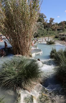 Saturnia, Italy - September 13, 2022:  People are bathing in the hot springs of Saturnia Therme, Saturnia, Tuscany, Italy