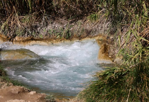 Saturnia, Italy - September 13, 2022:  People are bathing in the hot springs of Saturnia Therme, Saturnia, Tuscany, Italy