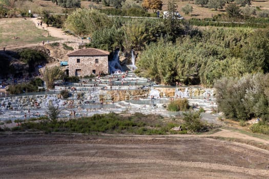 Saturnia, Italy - September 13, 2022:  People are bathing in the hot springs of Saturnia Therme, Saturnia, Tuscany, Italy