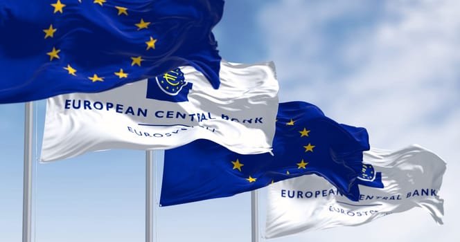 Frankfurt, DE, March 2023: Flags of the European Central Bank and European Union waving in the wind on a clear day. Illustrative editorial 3d illustration render