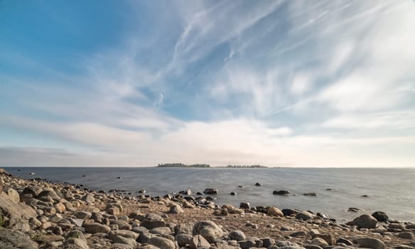 Rocky Shoreline over Ocean with a partly cloudy sky.