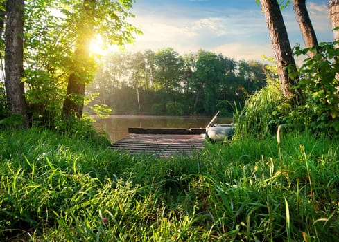 Small fishing pier on a river at sunrise