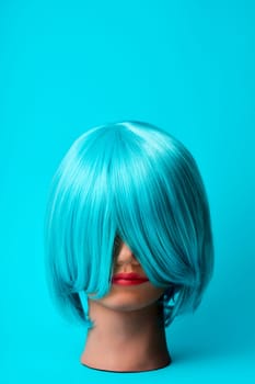 a mannequin head with a blue hair wig on a blue background