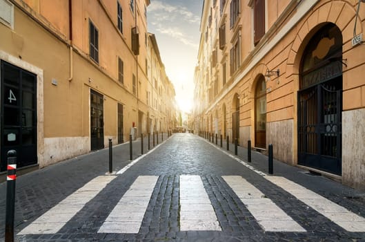 Sunrise over street with pedestrian crossing in Rome