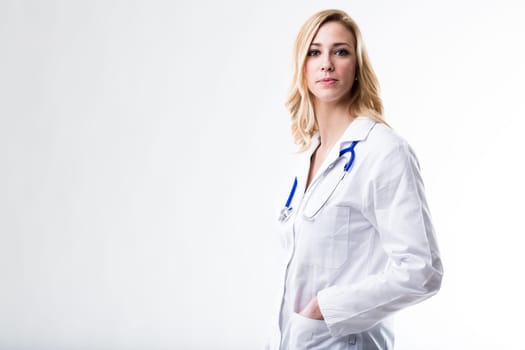 this beautiful blonde woman on a white coat is a doctor and she's waiting for her patient to tell her what's the problem because she's wellcoming
