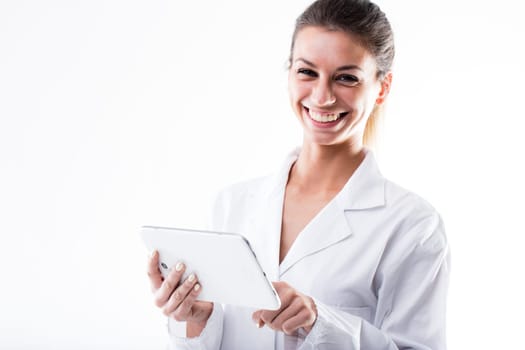 this lab scientist is touching a white digital tablet wearing a white coat and laughing or smiling a lot