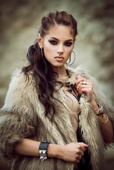 Portrait of a beautiful lady with flash tottoos posing outdoors near the sea
