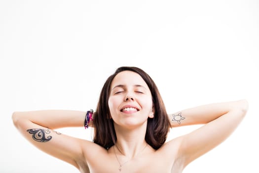 smiling relaxed woman (maybe naked) with her harms behind her neck dreaming her future holidays smiling with closed eyes