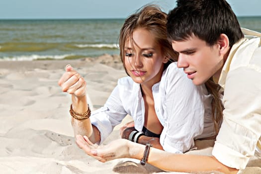 guy and his girlfriend are on the beach