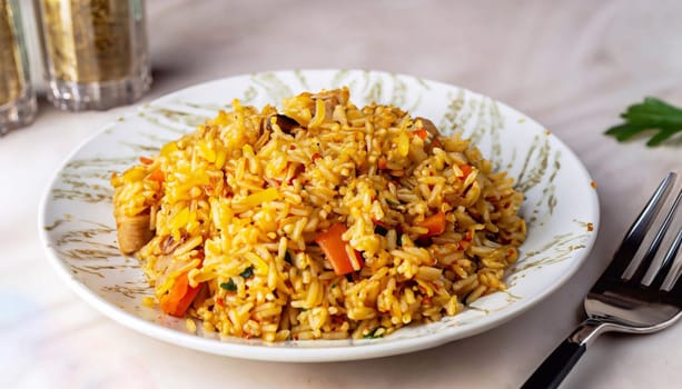 Delicious pilaf with meat served on white marble table, flat lay