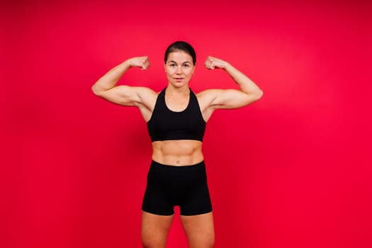 Portrait of female mixed martial arts fighter with a bandage and gloves on her hands.