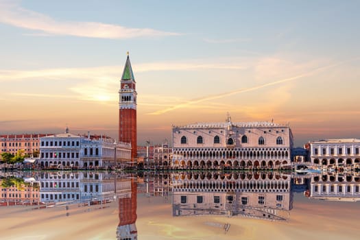 San Marco and Doge's Palace of Venice on the shore at sunset, view from the lagoon, Italy.