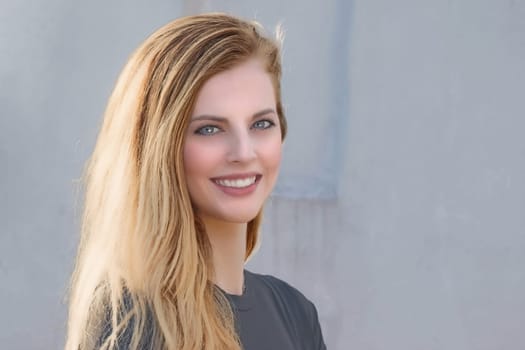 Portrait of smiling attractive young girl closeup. Horizontally.