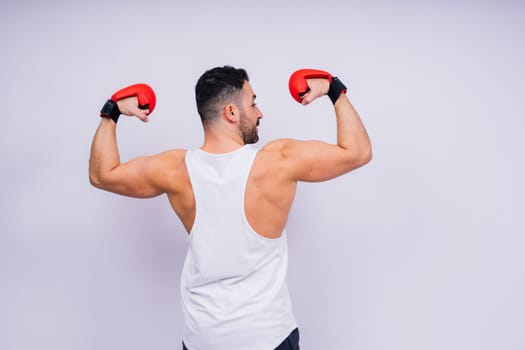Man boxer in red sport boxing gloves at a studio, copy space.