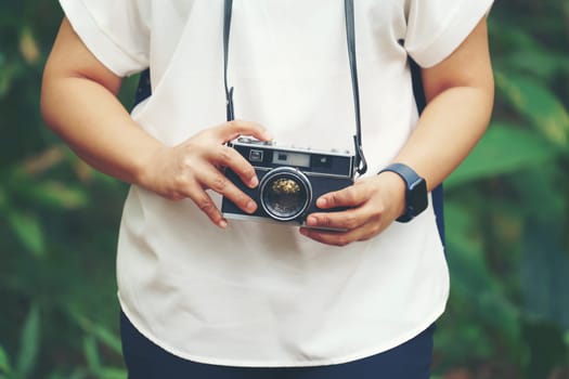 woman with vintage camera in park