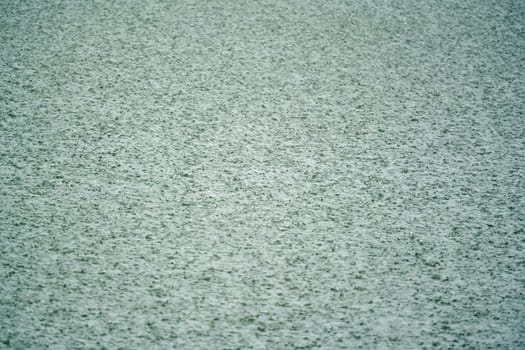 heavy rain hitting the water surface