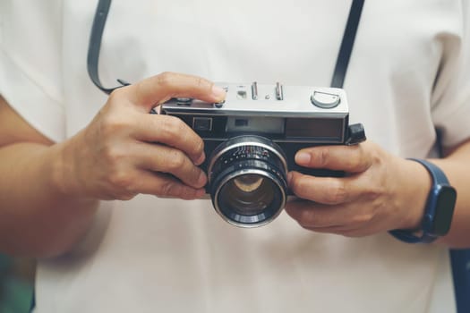 woman with vintage camera in park