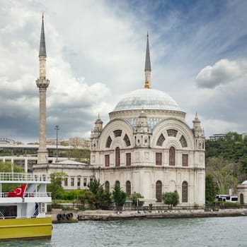 View from Bosphorus strait overlooking Baroque style Dolmabahce Mosque, located at the waterside of Kabatas, in Beyoglu district, Istanbul, Turkey