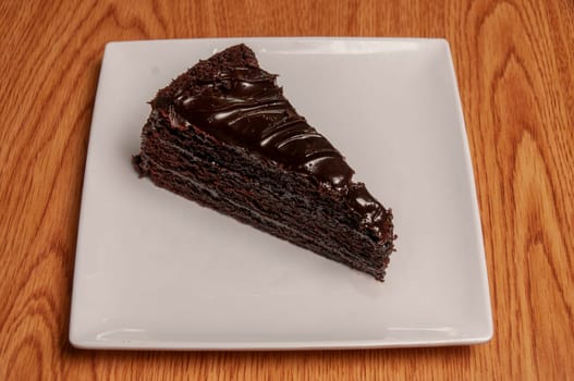 Piece of decadently delicious traditional chocolate fudge cake.