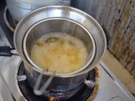 French fries in a deep fryerin hot oil . Preparation of french fries. FAST food