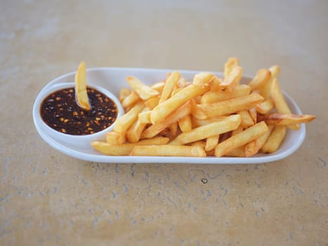 French fries, potato snack with THAI style spicy dipping sauce , fast food . SPACE FOR TEXT