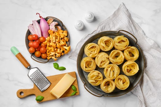 Trays with raw ingredients for mushroom pasta, overhead vie