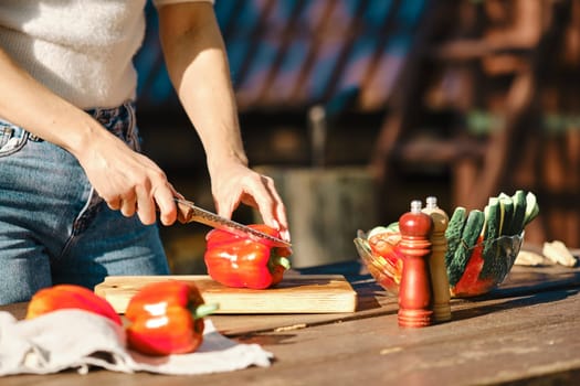 Closeup view of cutting fresh bell pepper for picnic
