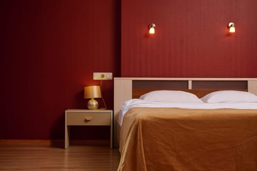 Stylish minimalistic interior of bedroom in red color