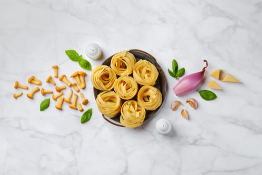 Composition with raw ingredients for mushroom pasta, top view