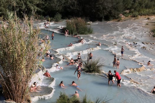 Saturnia, Italy - September 13, 2022:  People are bathing in the hot springs of Saturnia Therme, Saturnia, Tuscany, Italy