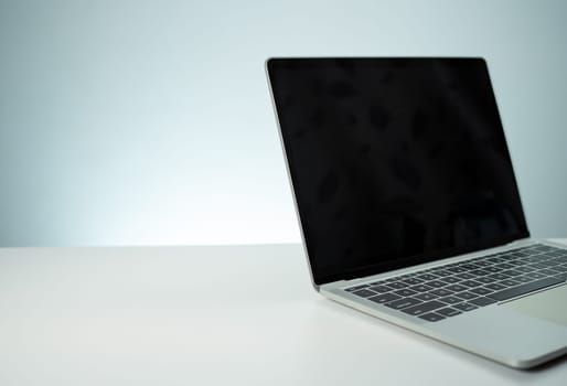 The computer image has a blank black screen. placed on a white table