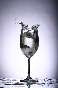 alcohol splash on the gray background close up
