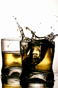 whiskey splash close up over white background