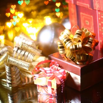 holiday gifts over the warm hearts background