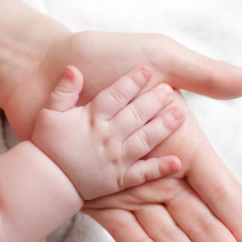 Mother holding her child's hand