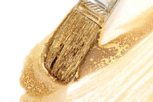 Close-up of paintbrush with gold paint