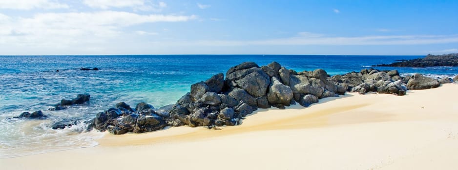 Gorgeous Beach Panorama with rocks in the foreground