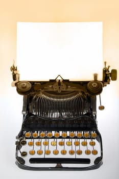 Vintage retro typewriter with blank white sheet on gradient background