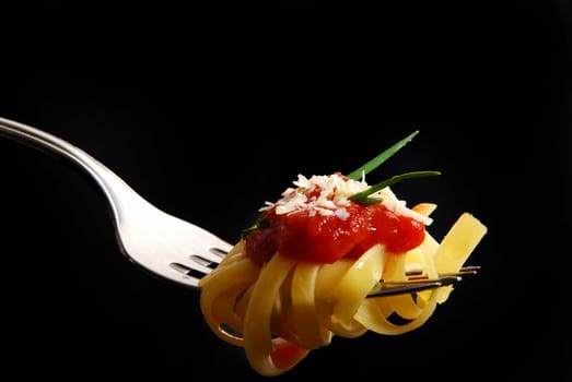fresh spaghetti on fork close up shoot
