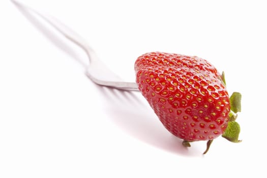 fork and fresh strawberry isolated on white background
