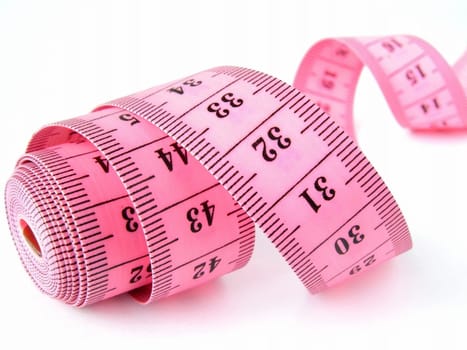 pink curved measuring tape fragment on white