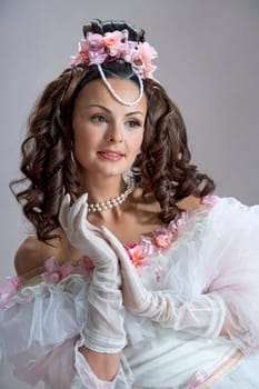 Fashion model posing in evening gown at retro style