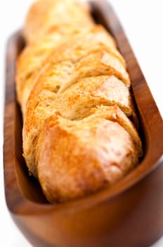 Isolated sliced baguette bread in wooden dish