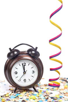 Waiting the New Year with clock, confetti and ribbons. Shallow depth of field