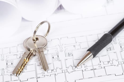 Construction plans with two keys and drawing tools. Shallow depth of field