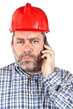 Angered construction worker with hardhat while talking with phone isolated on a white background