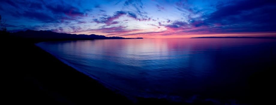 A beautiful sunset over the Strait of Juan de Fuca in Sequim. Panoramic photo.