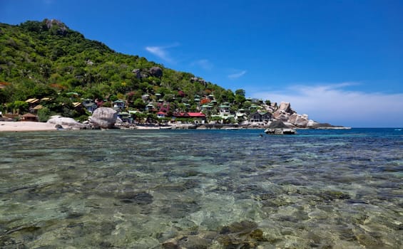 bay with clear water and resorts on koh tao - thailand