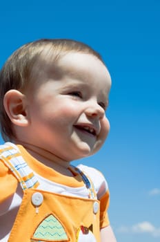 smiling baby is looking into the skies
