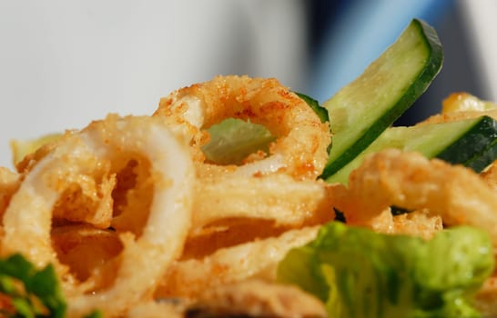 plate of fried calamari with fresh lemon slice